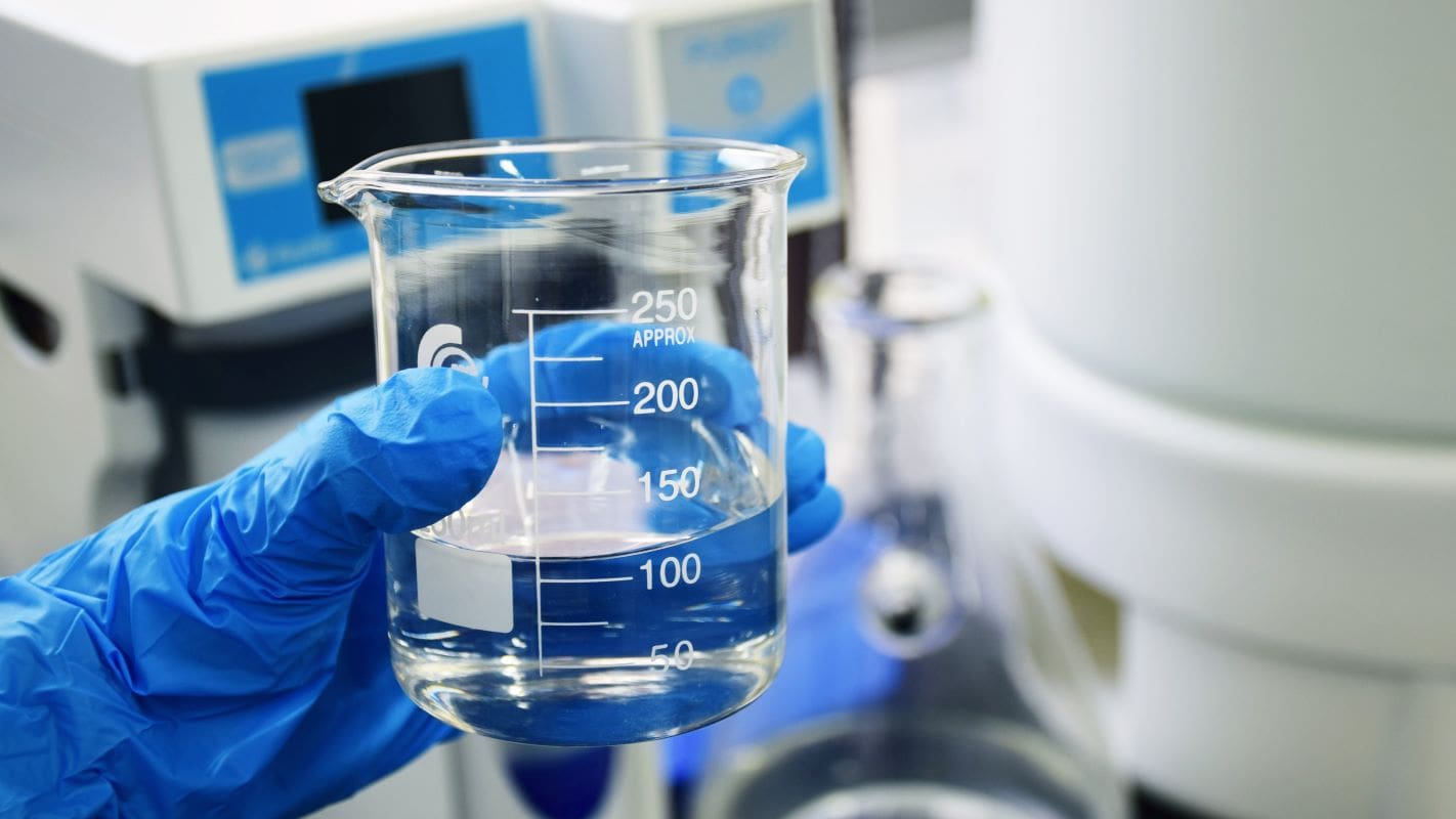 person holding a beaker