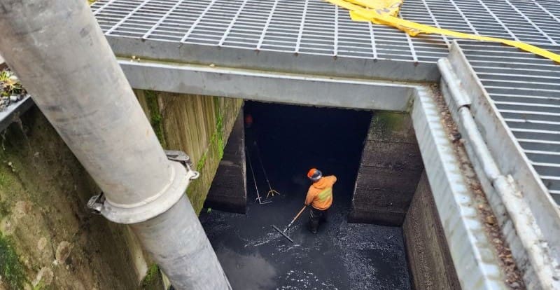 Worker cleaning underground vault